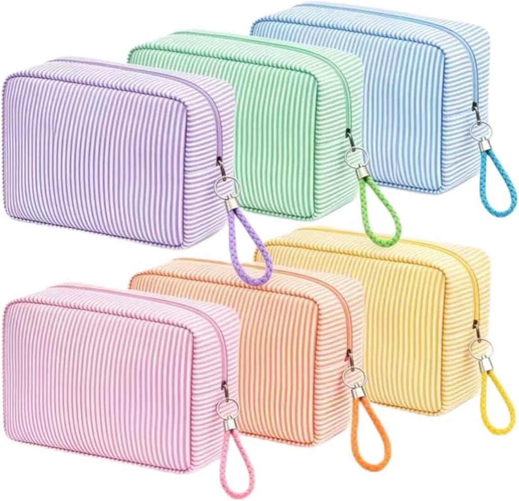 Six striped rectangular zippered pouches with wrist straps in purple, green, blue, orange, pink, and yellow, arranged in two rows against a white background.