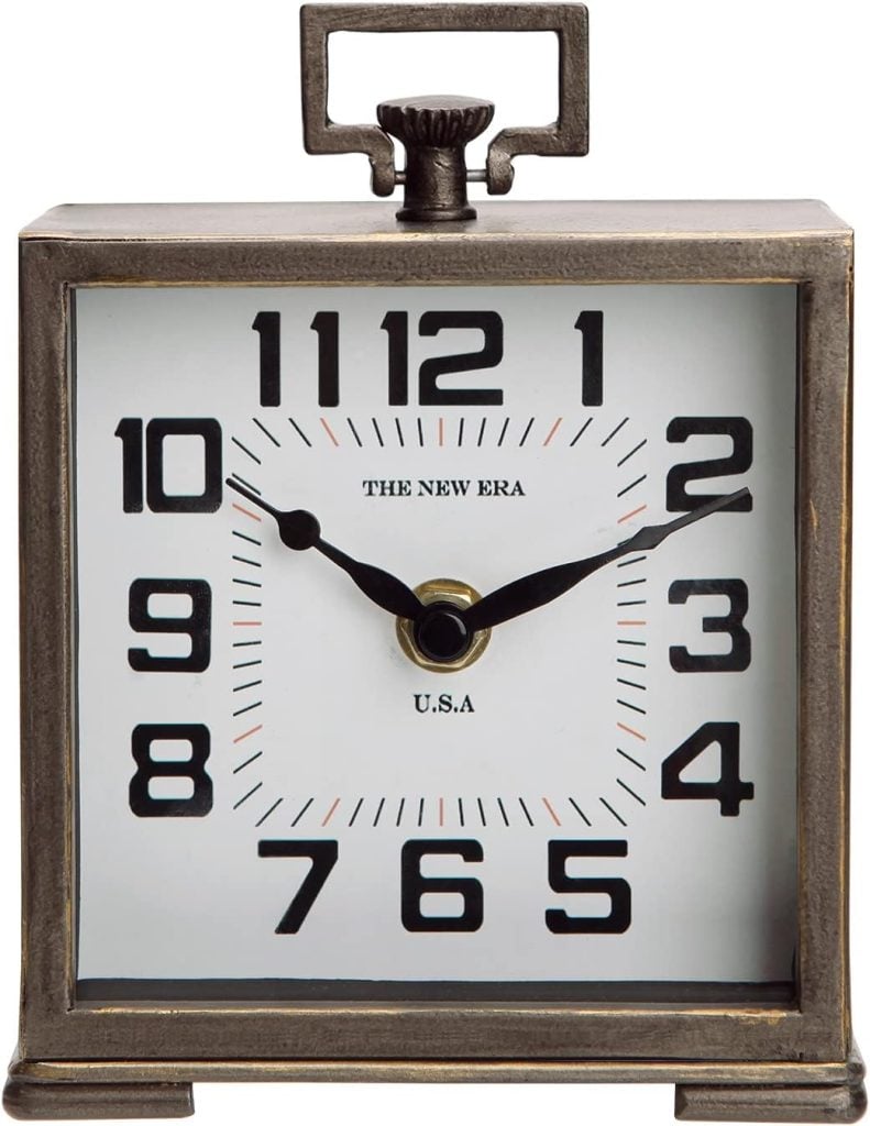 Square vintage-style tabletop clock displaying the time as 2:09. The clock has bold black numerals and metallic framing.