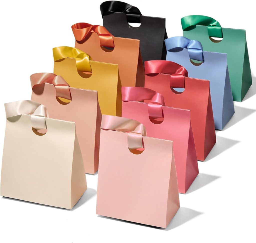 Ten gift bags in assorted colors, each with a matching satin bow handle, are arranged in staggered rows on a white background.