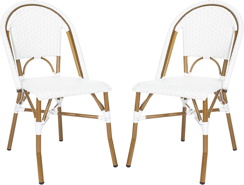 Two white, wicker-style dining chairs reminiscent of classic rattan furniture, with arched backs and light brown metal legs, facing each other on a plain white background.