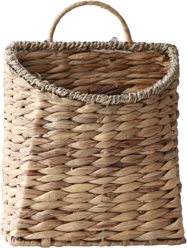 A rectangular woven basket made of natural straw with a single handle on top, shown empty against a white background—an ideal accent for spaces styled with rattan furniture.