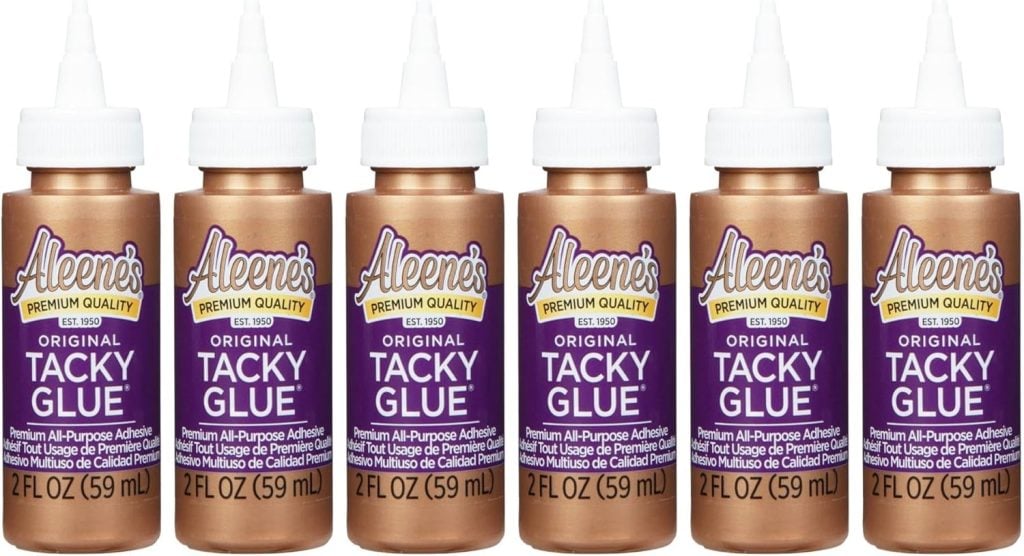 Six bottles of Aleene's Original Tacky Glue, each 2 fl oz (59 ml), are arranged in a row with white caps and purple labels.