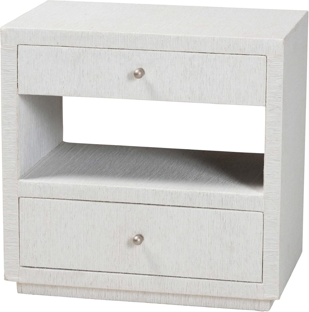 White nightstand with two drawers, metal knobs, and an open shelf in the middle. The surface and drawers have a textured finish that evokes the timeless elegance of classic rattan furniture.