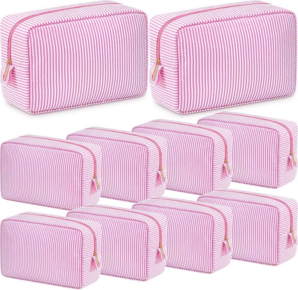 Nine identical pink and white striped zippered toiletry bags are arranged in three rows on a white background.