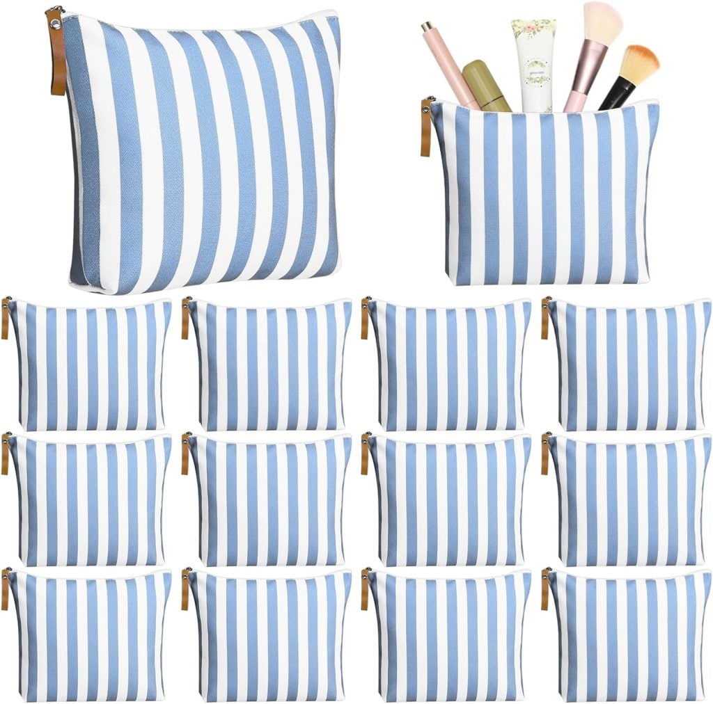Twelve blue and white striped zipper pouches, one shown open with makeup items inside, arranged on a white background.