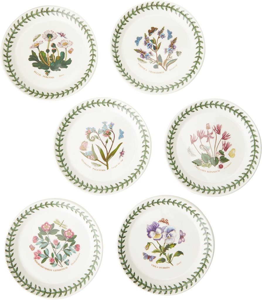 Six ceramic plates, each decorated with a different botanical illustration and labeled with the plant’s name, arranged in two rows. Plates have a green leaf border—perfect for serving dishes like a vibrant grilled peach salad.