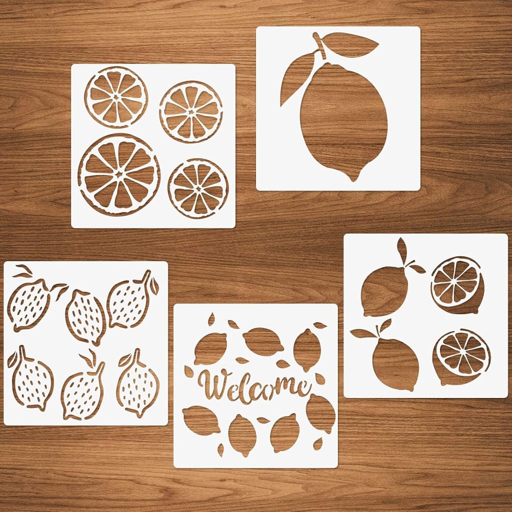 Five white stencils with lemon and citrus slice designs, including one with the word "Welcome," are arranged on a wooden surface.