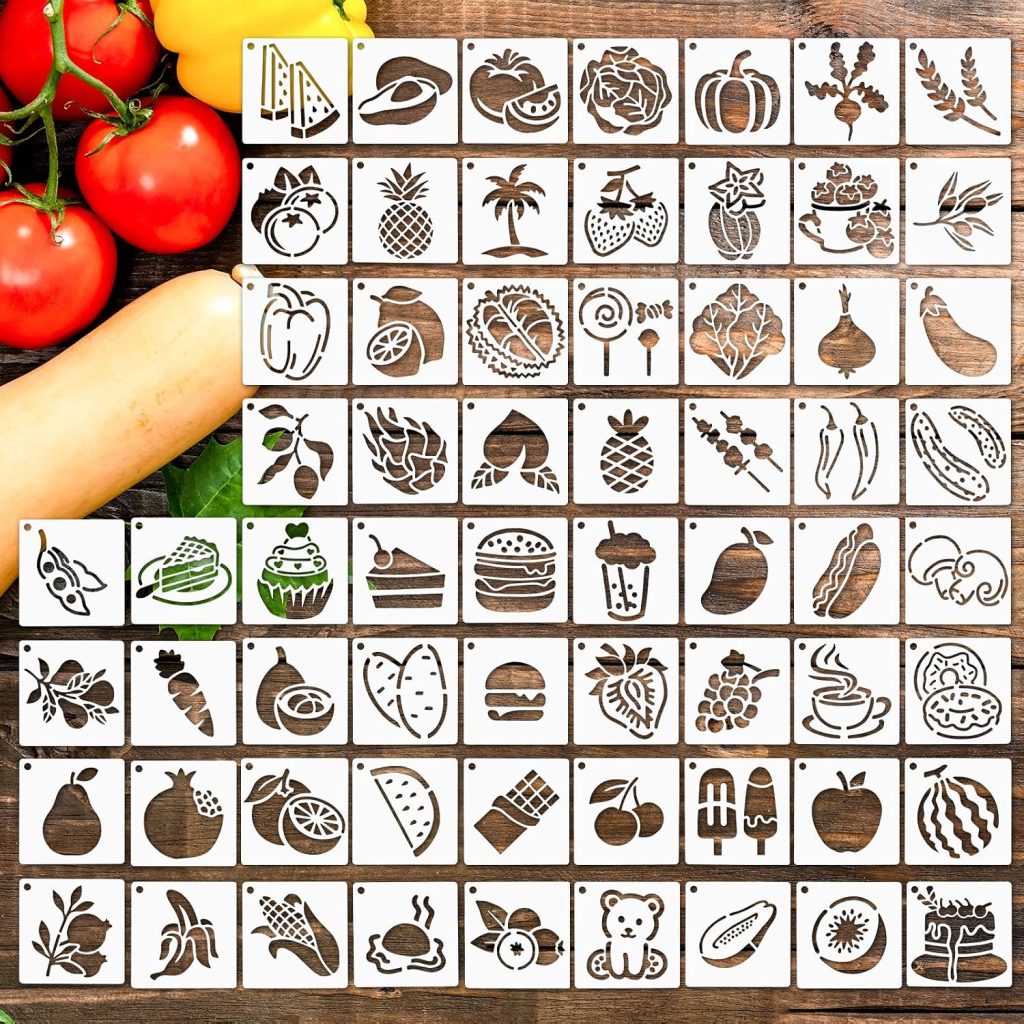 A grid of stencils with various food-themed cutouts, including fruits, vegetables, desserts, and drinks, is displayed on a wooden surface next to fresh tomatoes and a squash.