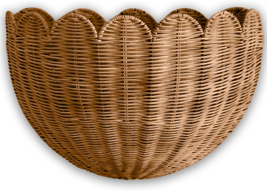 A half-circle wicker basket with a scalloped top edge, light brown in color, reminiscent of rattan furniture, isolated on a white background.