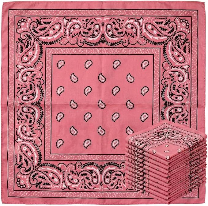 A stack of pink bandanas with a paisley pattern is displayed next to a single unfolded bandana showing the full design.