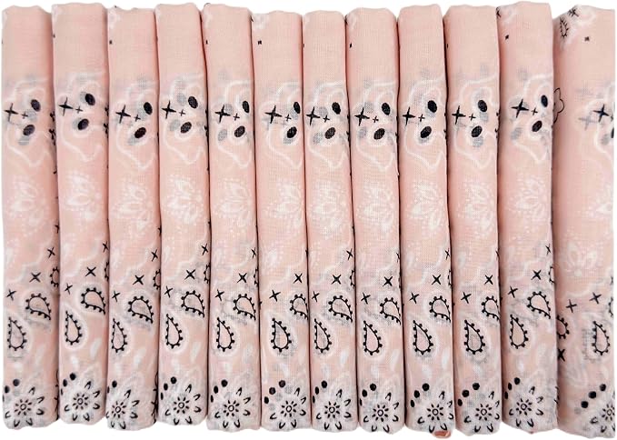 A row of twelve neatly folded, light pink bandanas with a white and black paisley pattern.